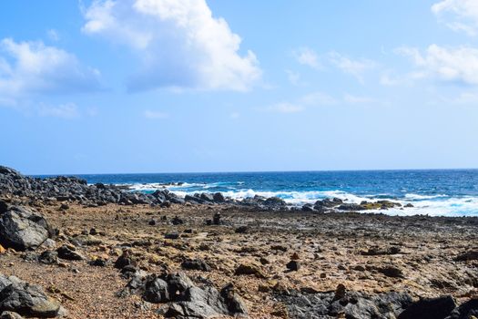 Arikok Natural Park on the island of Aruba in the Caribbean Sea with deserts and ocean waves on the rocky coast