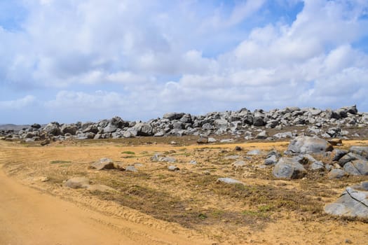 Arikok Natural Park on the island of Aruba in the Caribbean Sea with deserts and ocean waves on the rocky coast