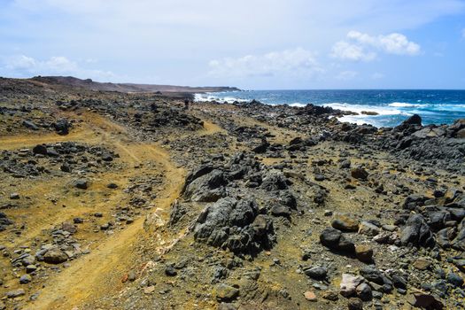 Arikok Natural Park on the island of Aruba in the Caribbean Sea with deserts and ocean waves on the rocky coast