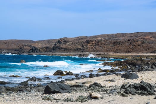 Arikok Natural Park on the island of Aruba in the Caribbean Sea with deserts and ocean waves on the rocky coast