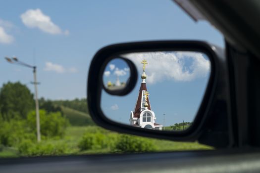 Church in the mirror of a car