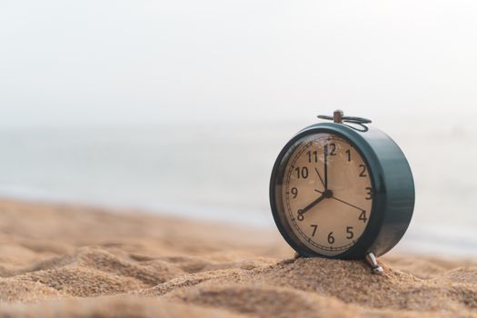 Selective focus of alarm clock on side table beside bed show 8 o'clock in the morning background.Time in life early bird person productive concept.