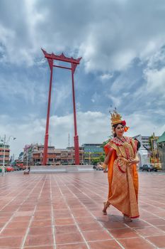 BANGKOK,THAILAND - SEPTEMBER 16,2018: Thai woman in traditional Thai costume dress show Thai dance at The Giant Swing (landmarks in Bangkok) on the SEPTEMBER 16,2018 in BANGKOK,THAILAND