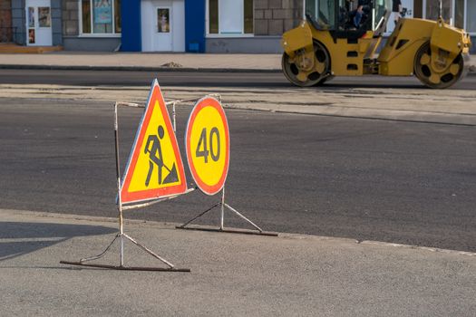 Road sign road repair on the background of road equipment in the city