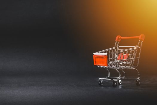 Shopping cart on dark background. Business, Copy space and online shopping concept. Selective focus