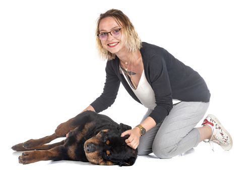 purebred rottweiler and woman in front of white background