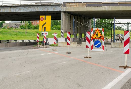 Road signs, detour, repair of the road on the asphalt bypass road near the residential area