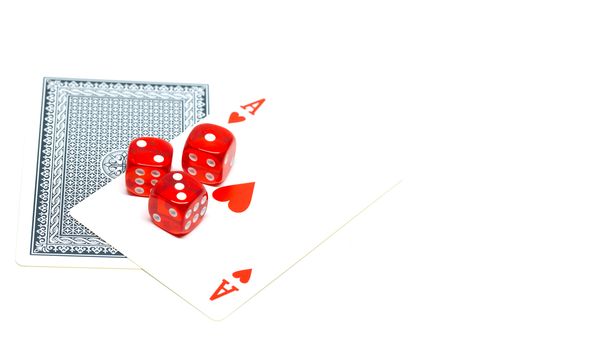 Red dice on ace of hearts on white background detail isolated