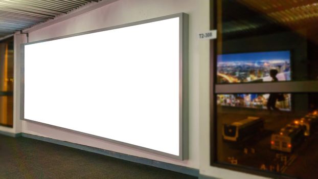 white blank billboard with copy space for your text message or content, advertising mock up banner at the airport, public information board with big window glass for airport view