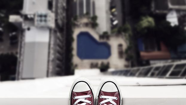 depression man stand on the edge of high building looking down at the ground and contemplating to commit suicide by jump buildings. commit suicide and major depressive disorder concept