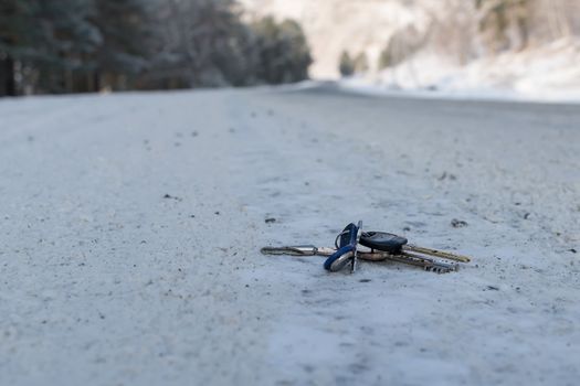 Lost a bunch of keys lying on the side of the road in the winter on the snow, near the roadway