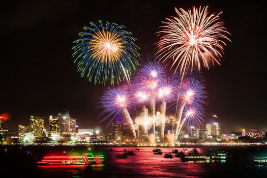 festive colorful firework light up the sky over the city at night scene for holiday festival and celebration background