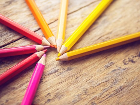 colorful color pencils on old wooden table with copy space