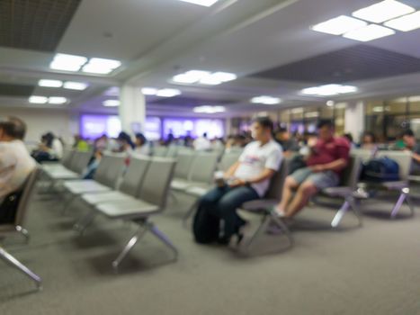 abstract blur of passengers sitting at the airport gate for waiting on boarding time