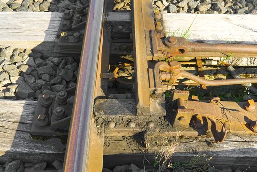 Railroad closeup. Railway tracks, Iron rusty train railway detail over dark stones
