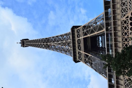 PARIS, FRANCE - APRIL 28, 2018: Beautiful view of the Eiffel Tower (Tour Eiffel) in a sunny spring day - Breathtaking view of the most known monument of Paris