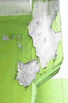 Close up of an old pillar with green peeling paint