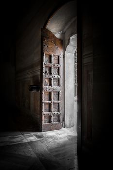 Light entering through gate in old church, peaceful moment.