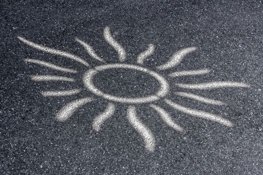 Sun shape with the rays on the asphalt