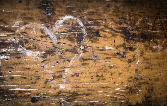 Symbol of heart made with white chalk on a wooden rough panel and rotten.