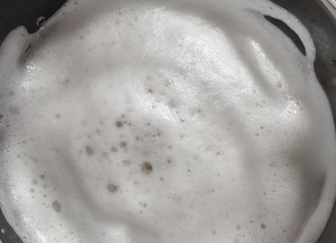 Fresh beer foam. Top view, extreme close-up. Texture and background for many uses.