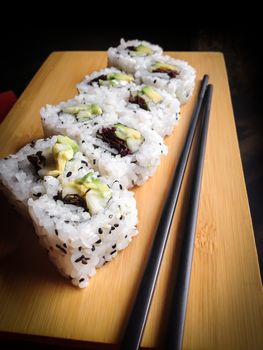 Close up of vegan sushi california roll. Shallow depth of field.