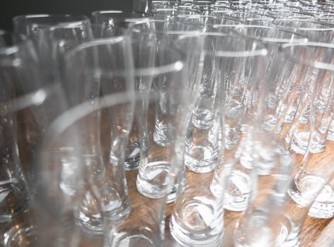 Close up of rows of empty beer glasses. Shallow DOF.