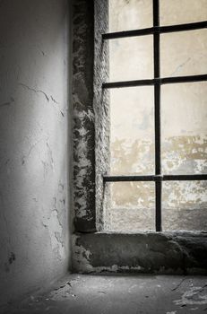 Contrasting light shines through the window of abandoned house. Shallow DOF.