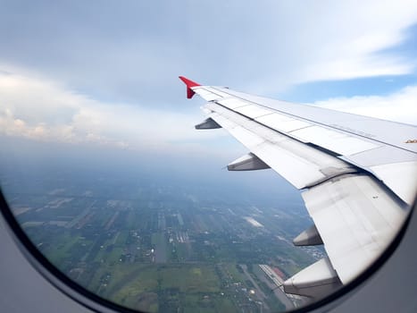 city view clouds and sky as seen through window of an aircraft. travel and vacation concept