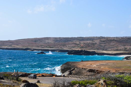 Arikok Natural Park on the island of Aruba in the Caribbean Sea with deserts and ocean waves on the rocky coast