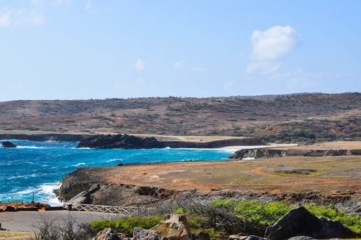 Arikok Natural Park on the island of Aruba in the Caribbean Sea with deserts and ocean waves on the rocky coast