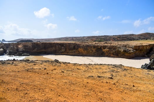 Arikok Natural Park on the island of Aruba in the Caribbean Sea with deserts and ocean waves on the rocky coast