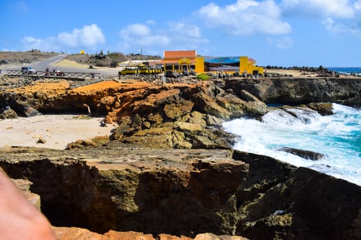 Arikok Natural Park on the island of Aruba in the Caribbean Sea with deserts and ocean waves on the rocky coast