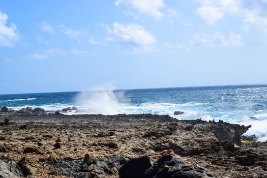 Arikok Natural Park on the island of Aruba in the Caribbean Sea with deserts and ocean waves on the rocky coast