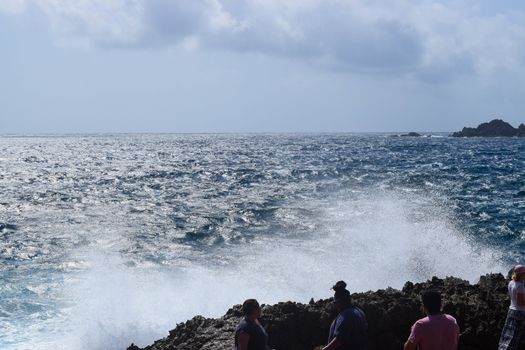 Arikok Natural Park on the island of Aruba in the Caribbean Sea with deserts and ocean waves on the rocky coast