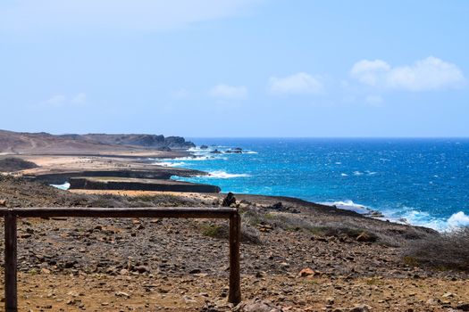 Arikok Natural Park on the island of Aruba in the Caribbean Sea with deserts and ocean waves on the rocky coast