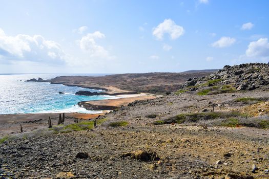 Arikok Natural Park on the island of Aruba in the Caribbean Sea with deserts and ocean waves on the rocky coast