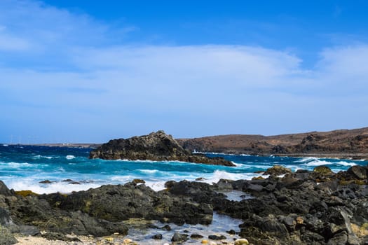 Arikok Natural Park on the island of Aruba in the Caribbean Sea with deserts and ocean waves on the rocky coast