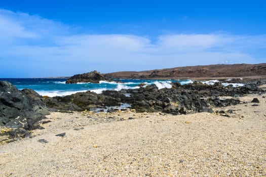 Arikok Natural Park on the island of Aruba in the Caribbean Sea with deserts and ocean waves on the rocky coast