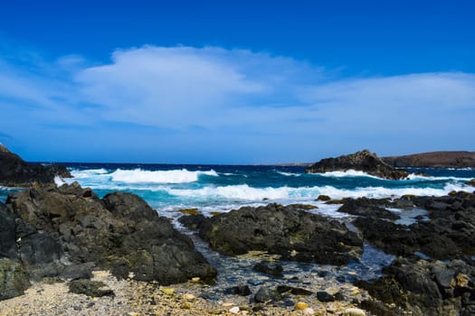 Arikok Natural Park on the island of Aruba in the Caribbean Sea with deserts and ocean waves on the rocky coast