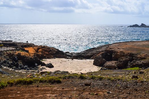 Arikok Natural Park on the island of Aruba in the Caribbean Sea with deserts and ocean waves on the rocky coast