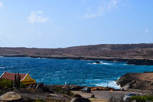 Arikok Natural Park on the island of Aruba in the Caribbean Sea with deserts and ocean waves on the rocky coast