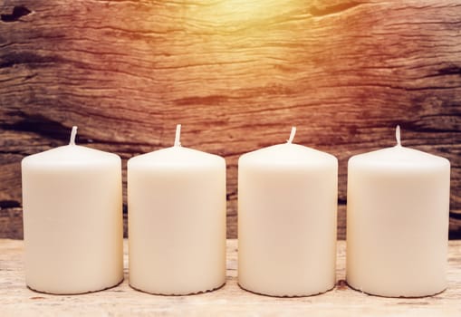 group of white candle with wooden background