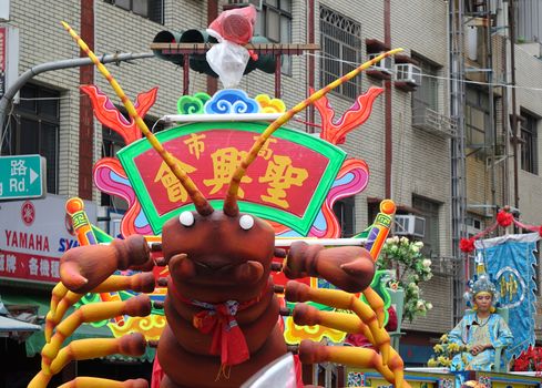 KAOHSIUNG, TAIWAN -- JULY 9, 2016: A large float in the shape of a lobster is part of a parade at a traditional religious temple ceremony.
