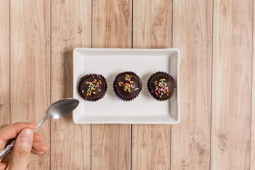 Fresh chocolate ball cakes sprinkled with colorful sugar balls.