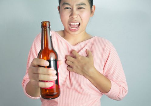 Asian young woman suffering from chest pain caused by heart disease from drink many alcohol. Dangerous lifestyle warning concept.