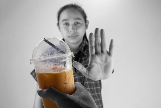 Asian young woman refuse Iced Thai milk tea, Healthy lifestyle and diet concept.