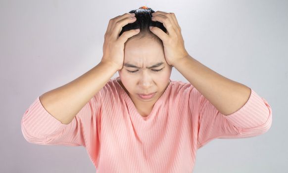 Asian young woman holding her hand to the head while have chronic severe headache migraine. Health and medical concept.