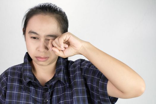 Asian young woman suffering from irritated eye, allergic or itching from dust. Optical health care concept.