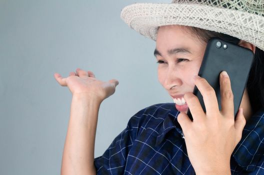 Asian young woman smiling while talking on phone in vacation day, Isolated on grey background.